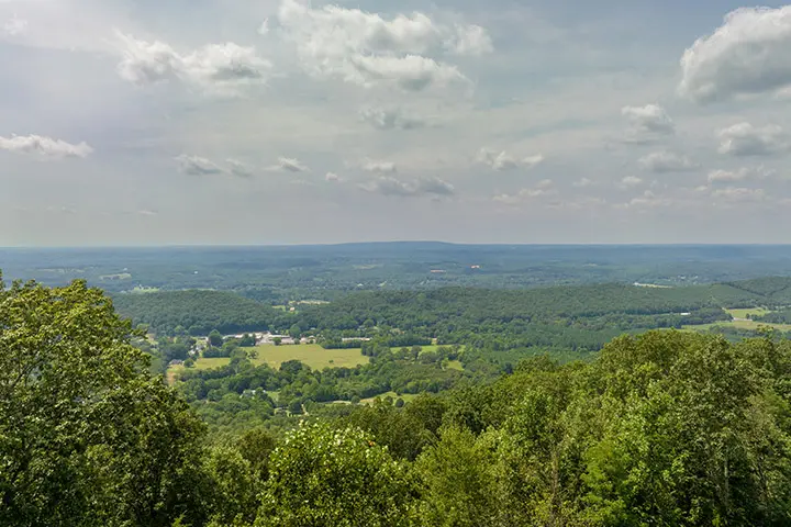 A view from the top of a mountain overlooking a forest.