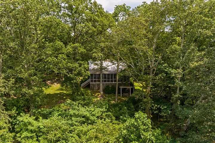 An aerial view of a house surrounded by trees.