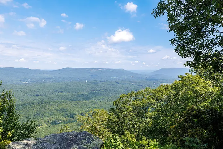 A view of the blue ridge mountains from the top of a rock.