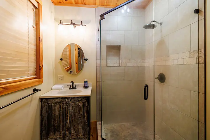 A bathroom with a shower stall and sink.