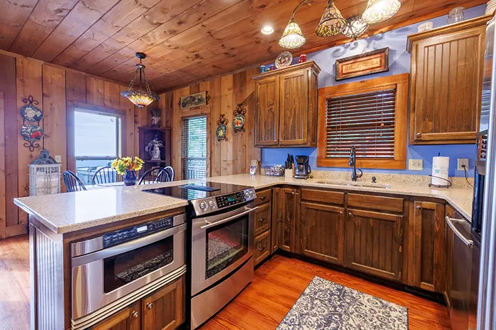 A kitchen with wood paneling and stainless steel appliances.