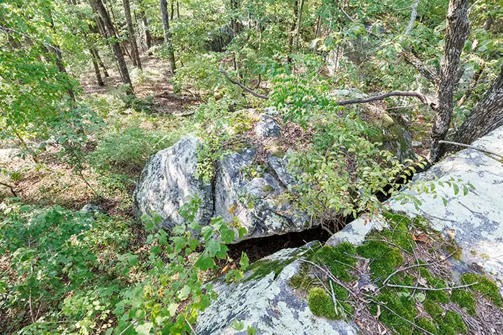 An aerial view of a rock formation in the woods.