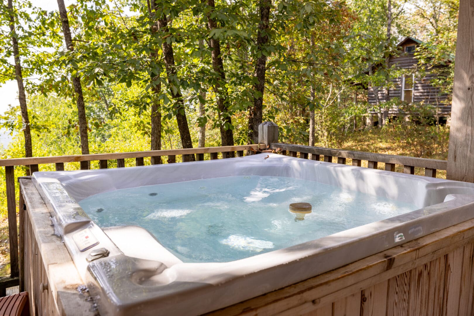 A hot tub on the deck of a cabin.