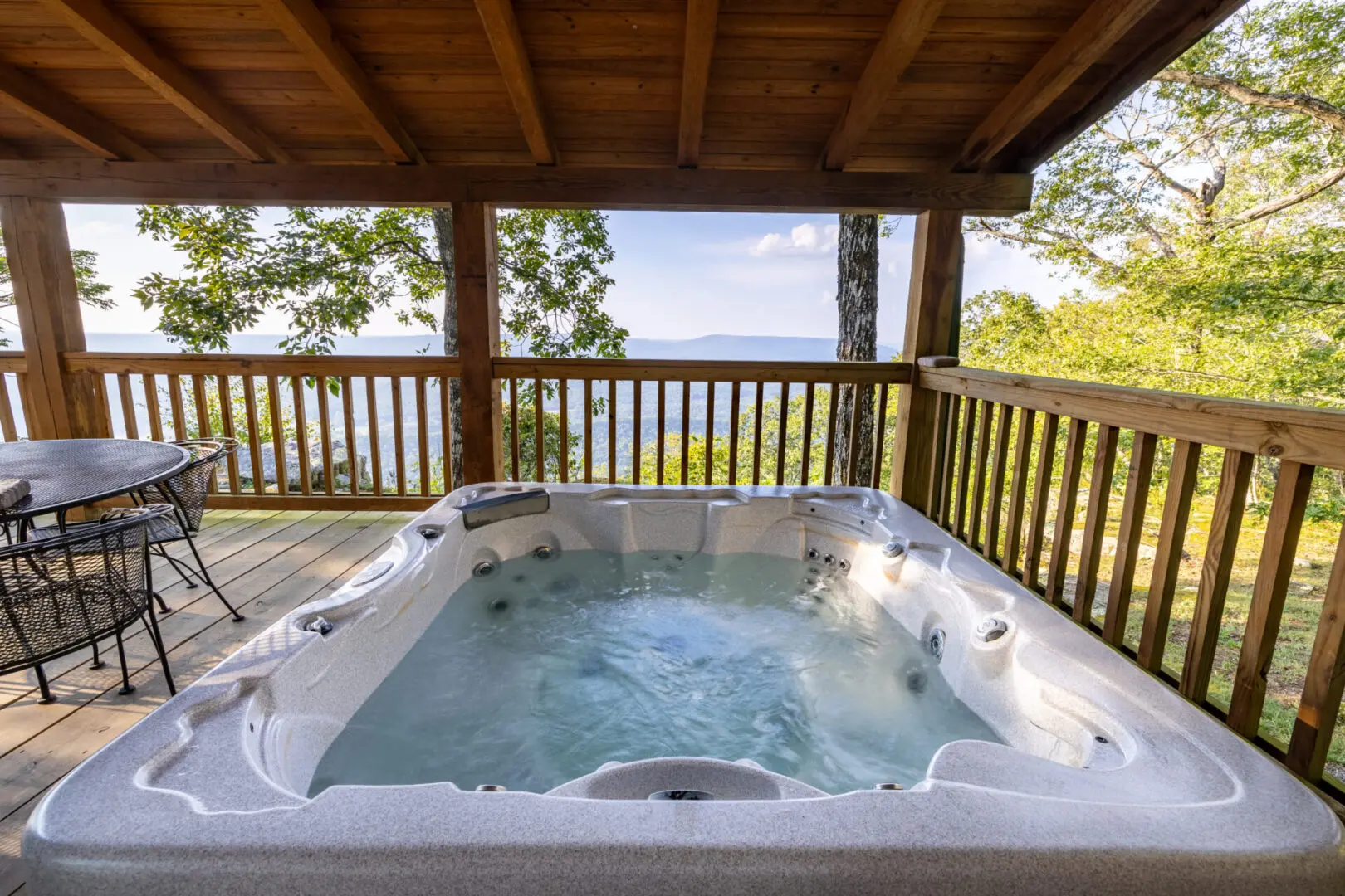A hot tub on the deck of a cabin.