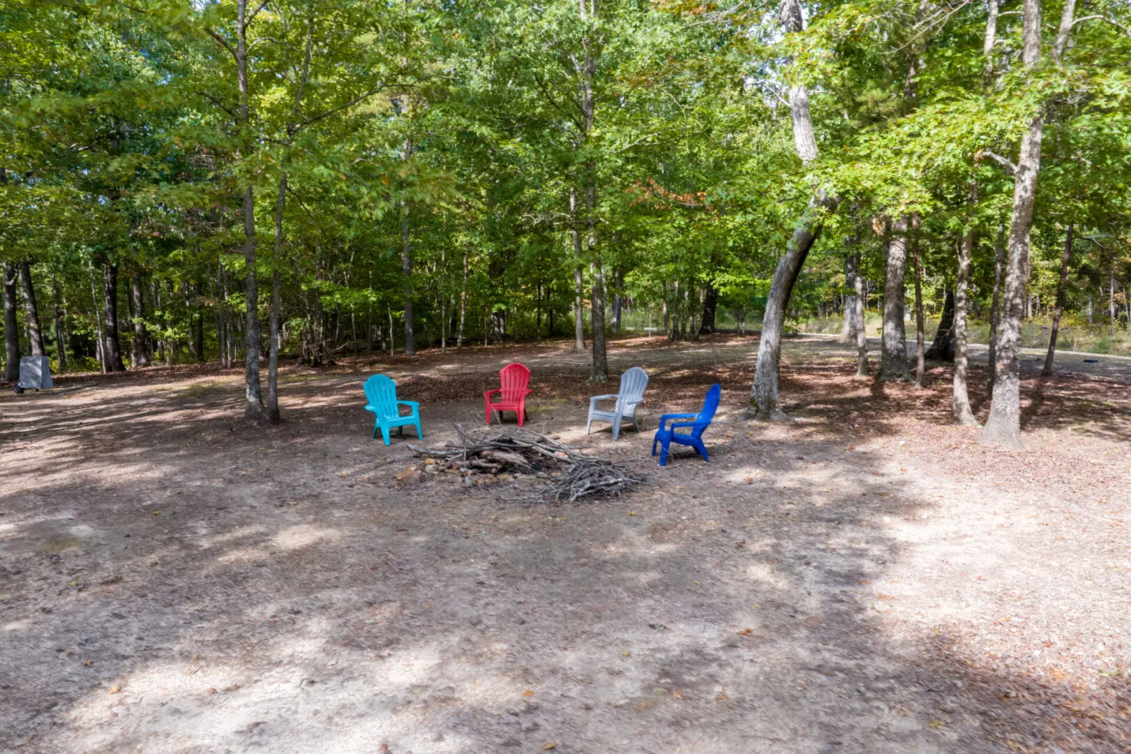 A fire pit in the middle of a wooded area.