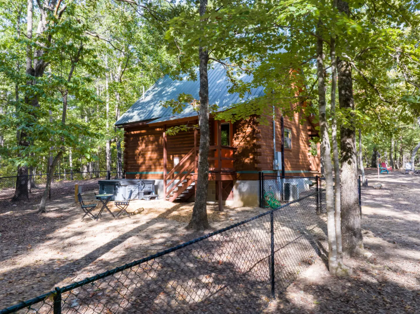 A cabin surrounded by trees in the woods.