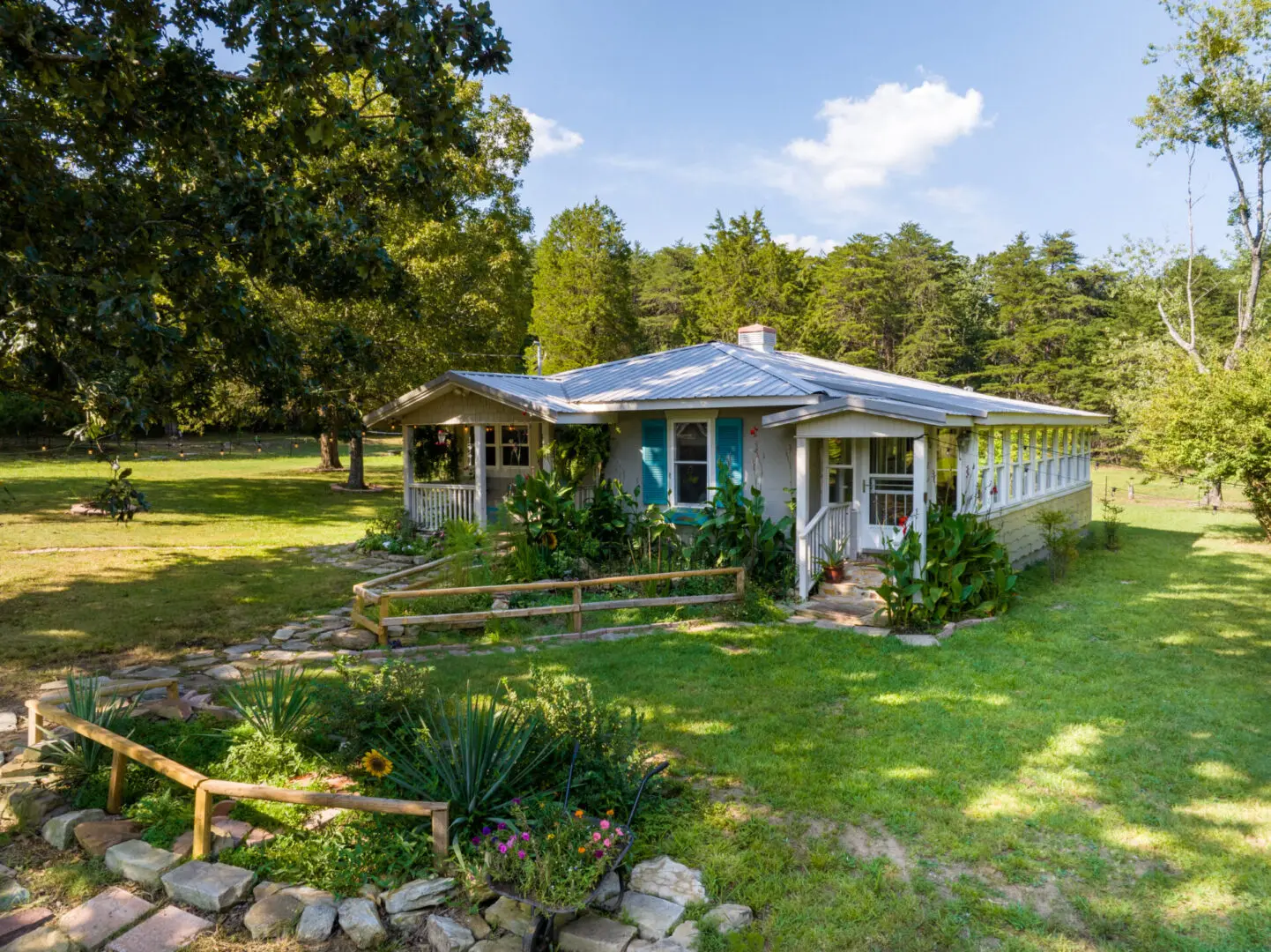 A cozy cabin nestled in the middle of a lush green field, perfect for Mentone cabin rentals.
