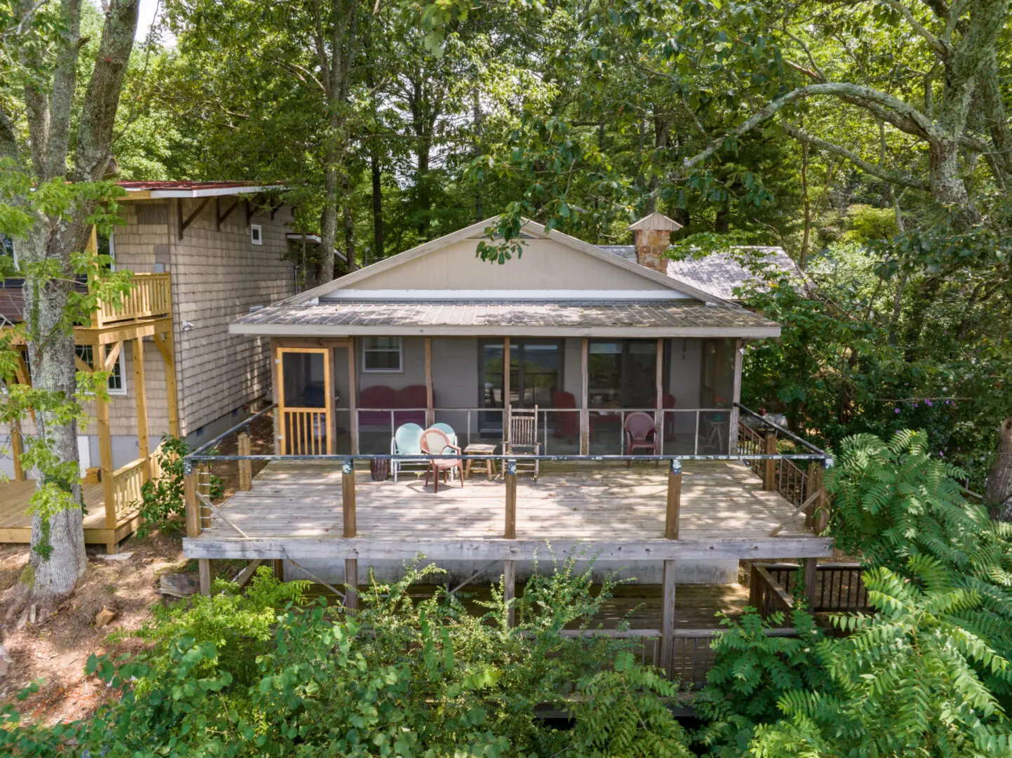A breathtaking aerial view of a secluded cabin nestled among the lush woods of Mentone.