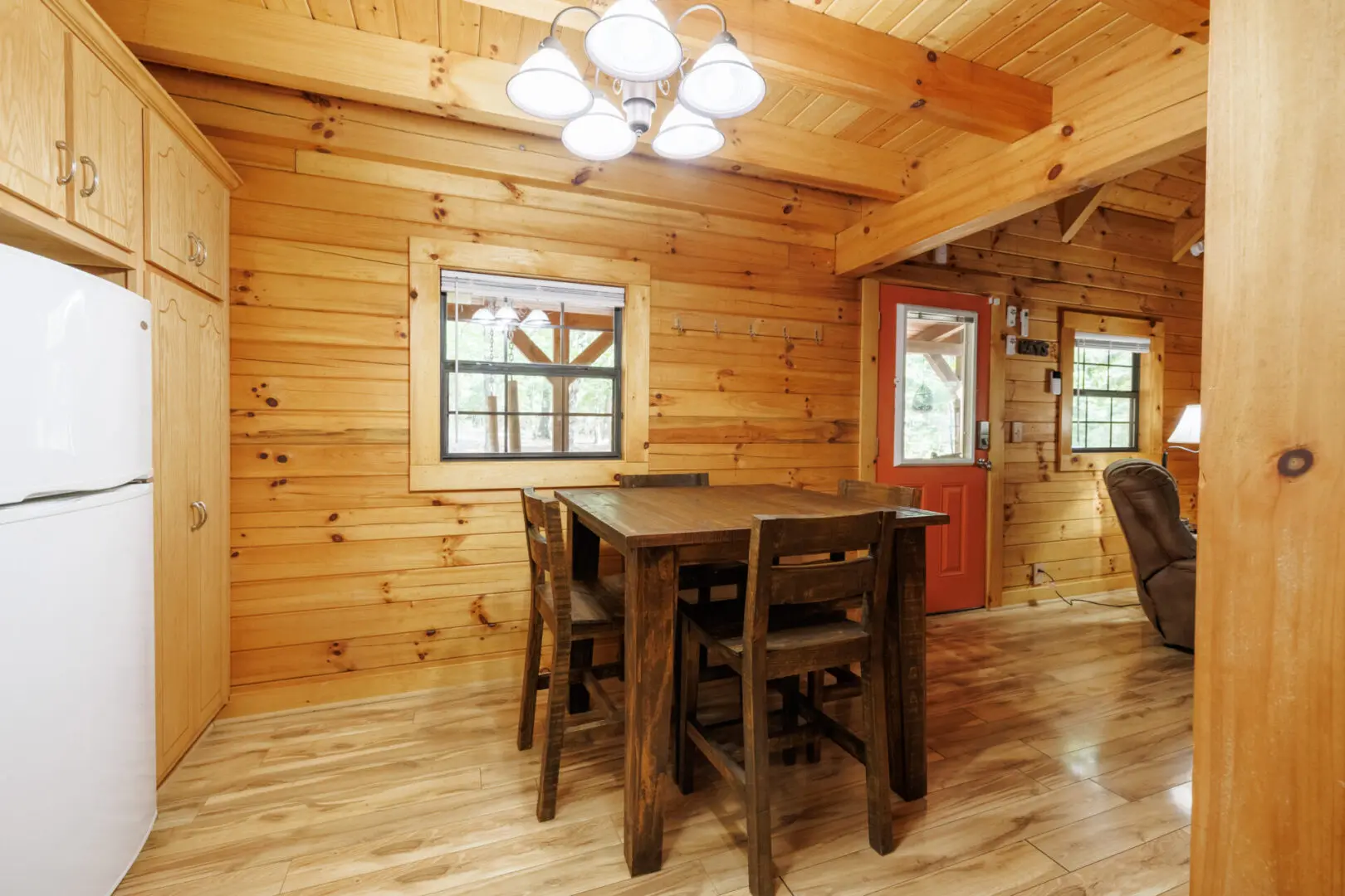 A kitchen and dining area in a log cabin.