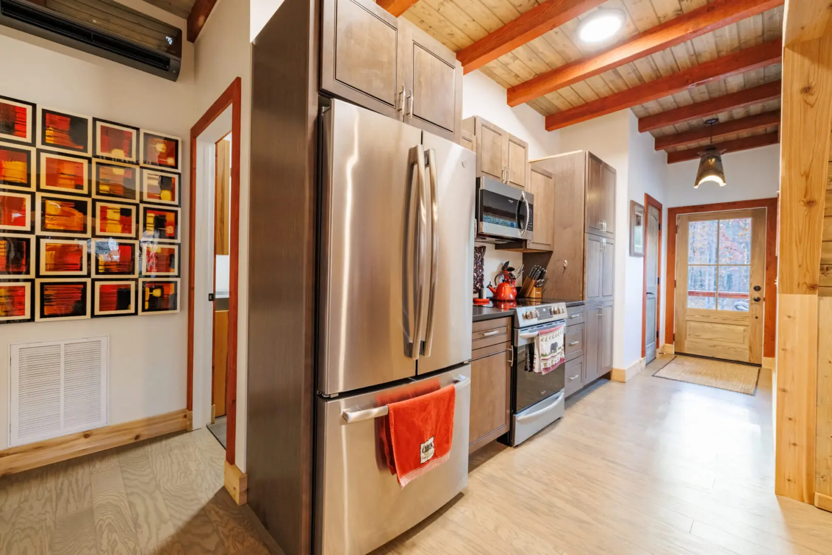 A kitchen with a stainless steel refrigerator and stove at Little River Point with Sauna.