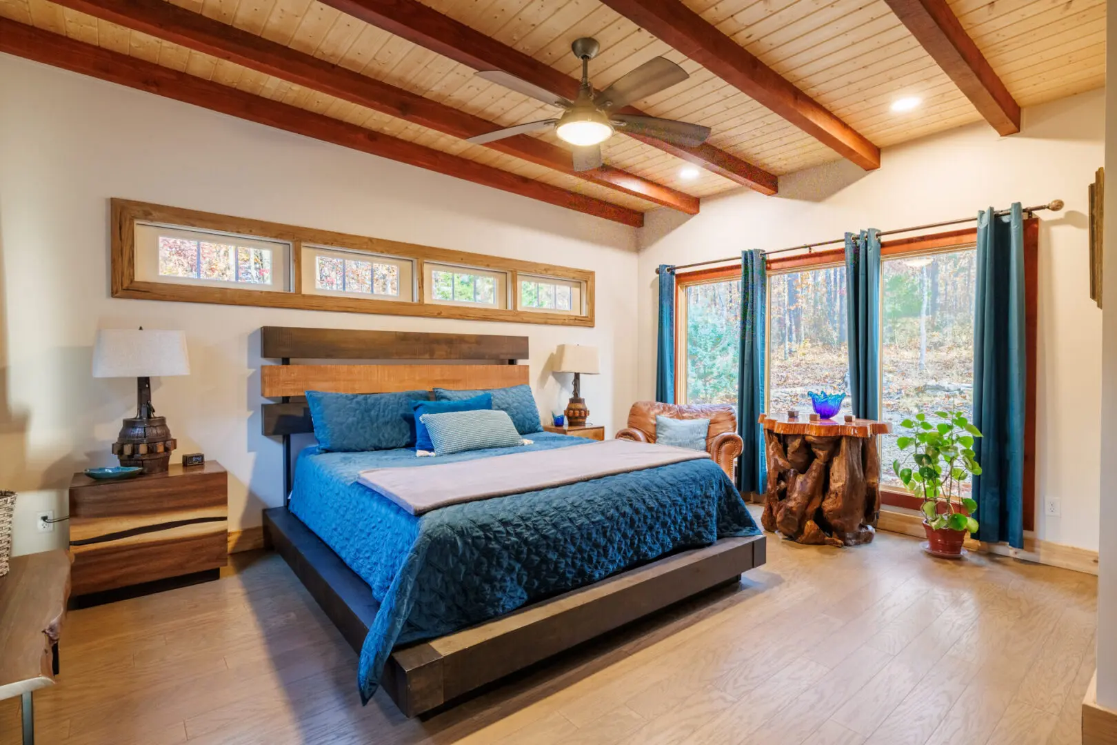 A cozy bedroom with a bed and a ceiling fan at Little River Point, perfect for relaxation.