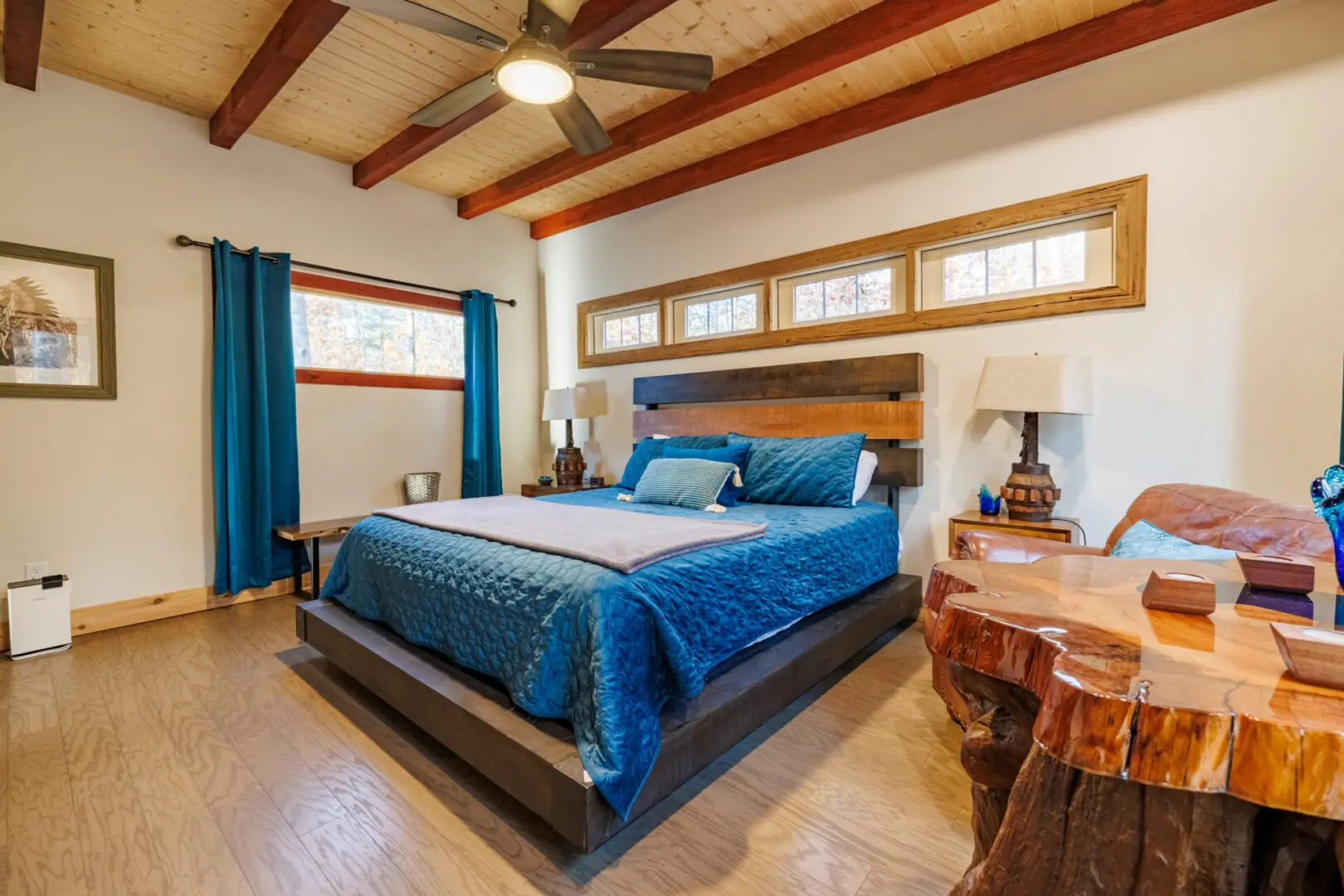 A Little River Point bedroom with a bed and a ceiling fan.