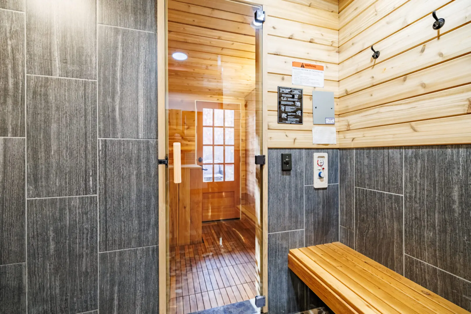 Little River Point offers a serene sauna experience, with a wooden bench and a glass door providing an inviting ambiance.