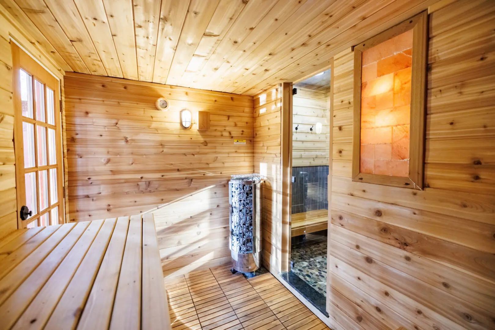 A cozy wooden sauna room with a bench at the Little River Point.