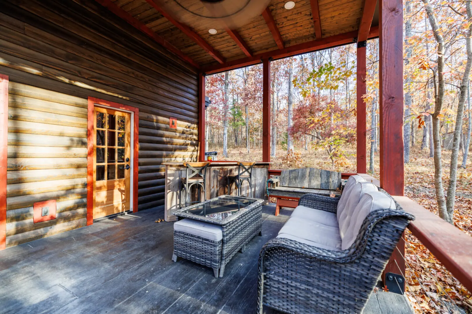 A Little River Point porch with wicker furniture and a fireplace, complete with a sauna.