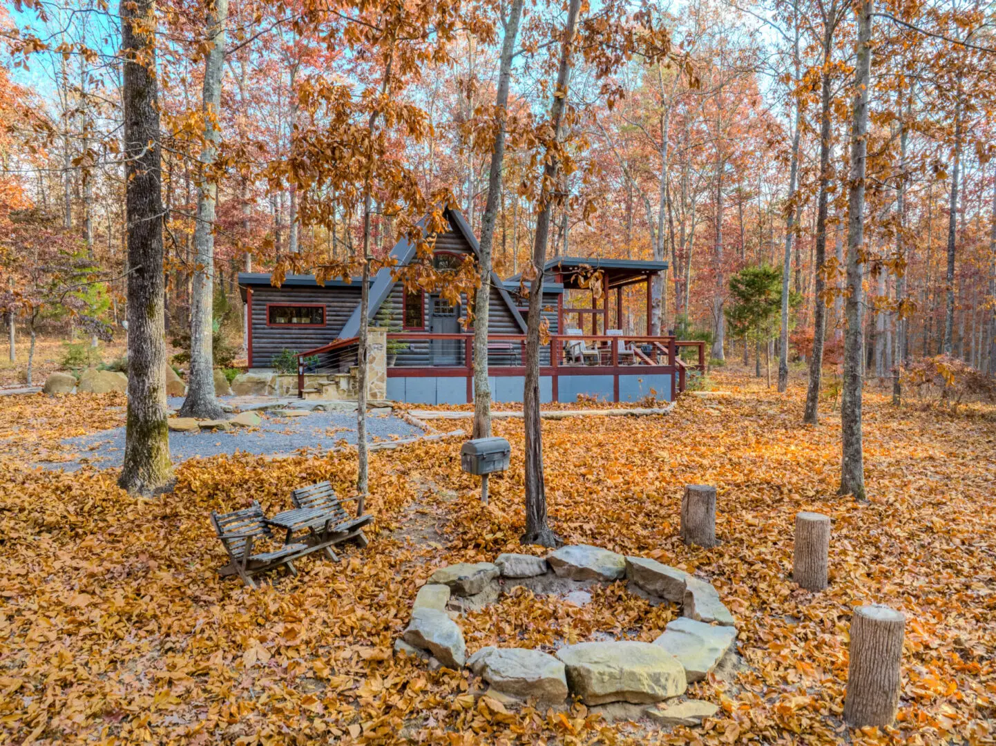 A cozy cabin in the woods with a fire pit at Little River Point, perfect for relaxation and unwinding amidst nature's beauty.