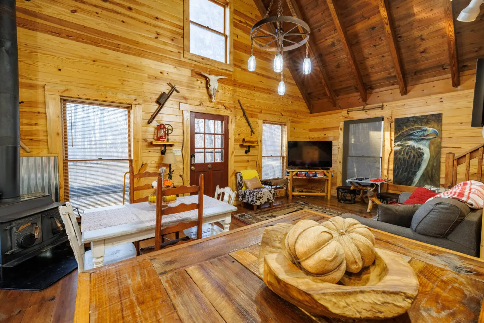 A cozy living room in a log cabin with a fireplace, perfect for a vacation retreat.