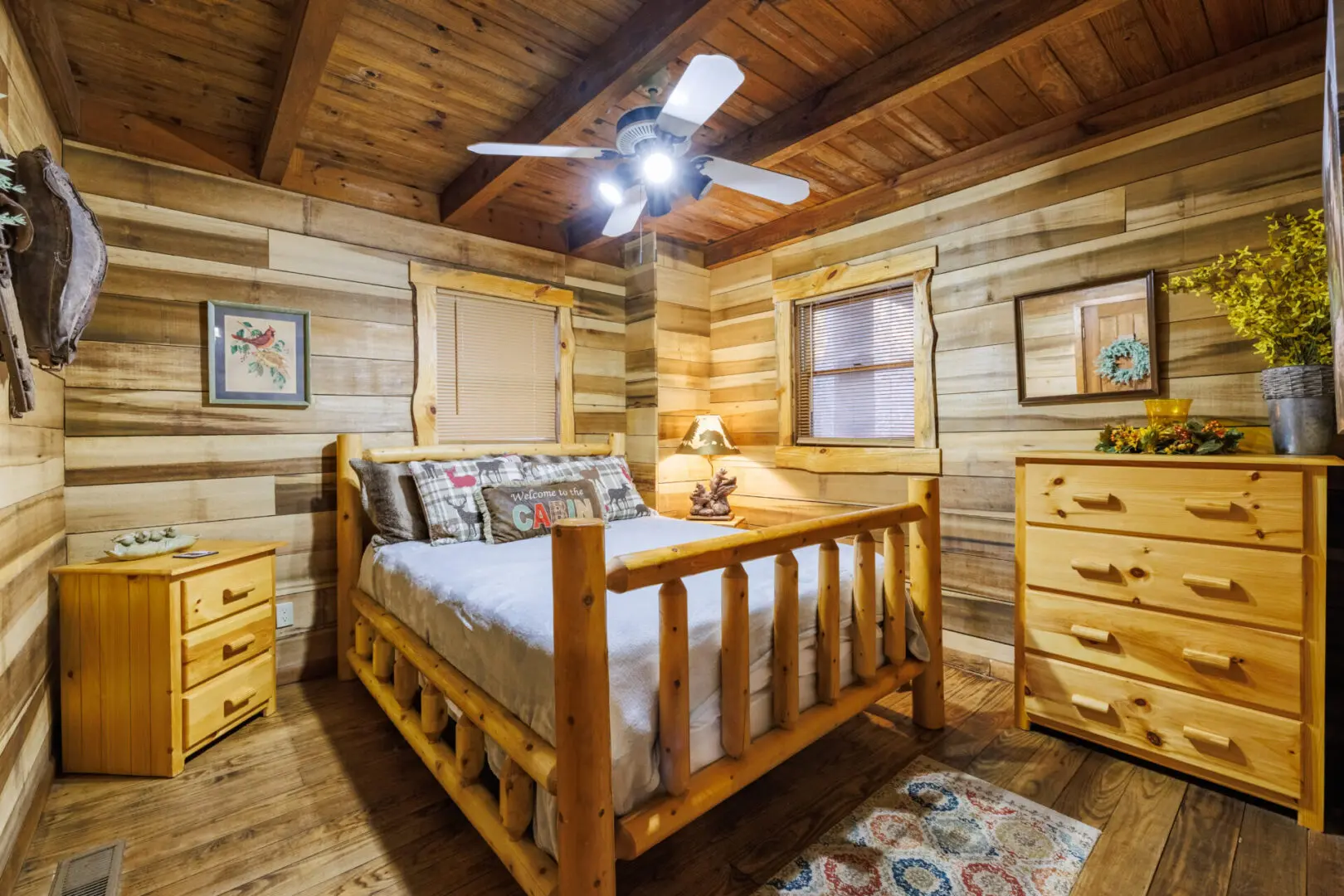 A cozy bedroom in a log cabin, perfect for your vacation getaway, furnished with a comfortable bed and dresser.