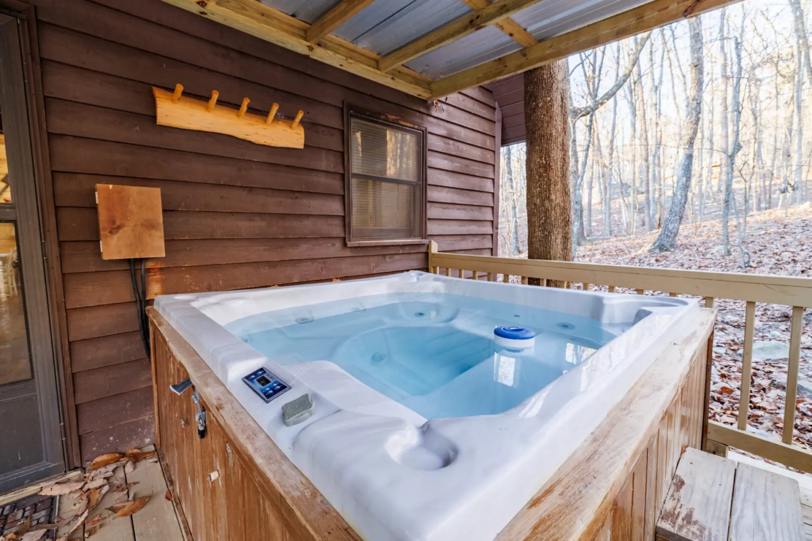 A relaxing hot tub on the deck of a vacation cabin.