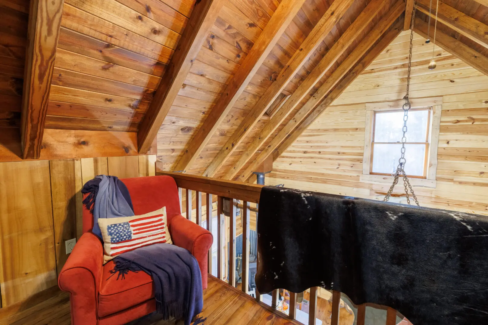 A chair with an american flag on it in a log cabin, perfect for a vacation getaway.