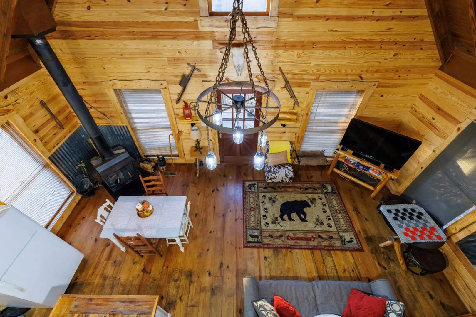 An aerial view of a cozy living room in a log cabin perfect for a relaxing vacation.