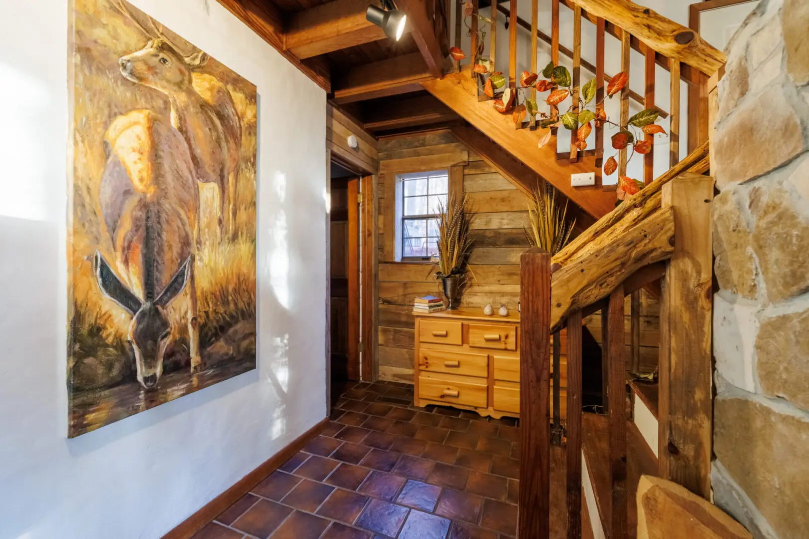 A vacation-themed wooden staircase with a painting on the wall.