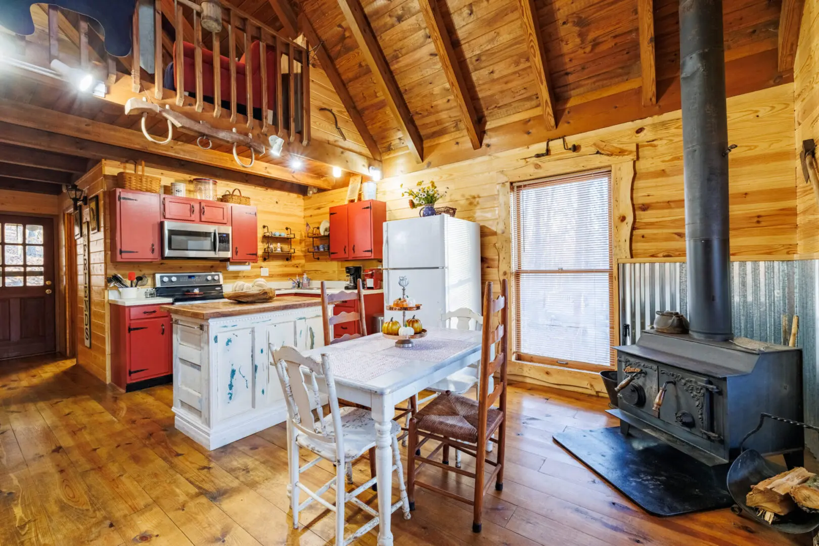 A rustic log cabin kitchen with a cozy wood stove, perfect for a relaxing vacation.