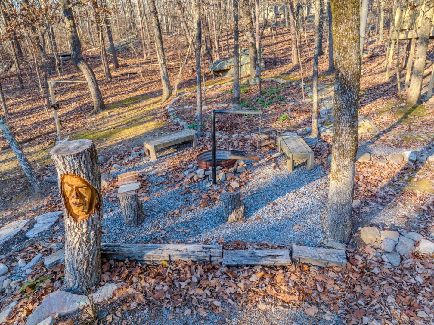 A vacation getaway with an aerial view of a wooded area featuring a fire pit perfect for outdoor gatherings.