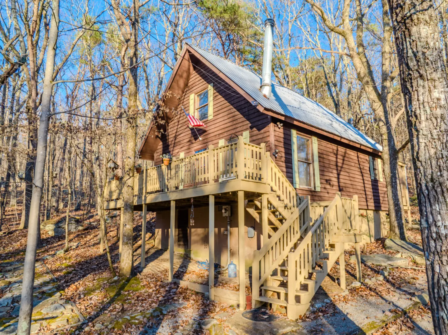A serene vacation cabin nestled in the peaceful woods, accessible via charming stairs.